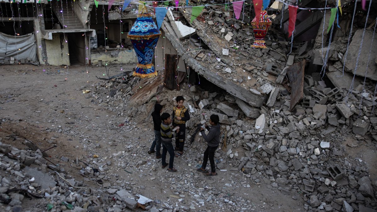 Palestinian children seen under Ramadan decorations next to their destroyed homes in Khan Younis, southern Gaza Strip, Palestine, Feb. 28, 2025. (EPA Photo)
