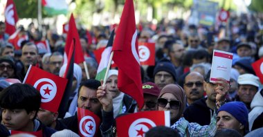 People commemorate the 13th anniversary of the Tunisian uprising in Avenue Habib Bourguiba, Tunis, Jan. 14, 2024. (AP Photo)
