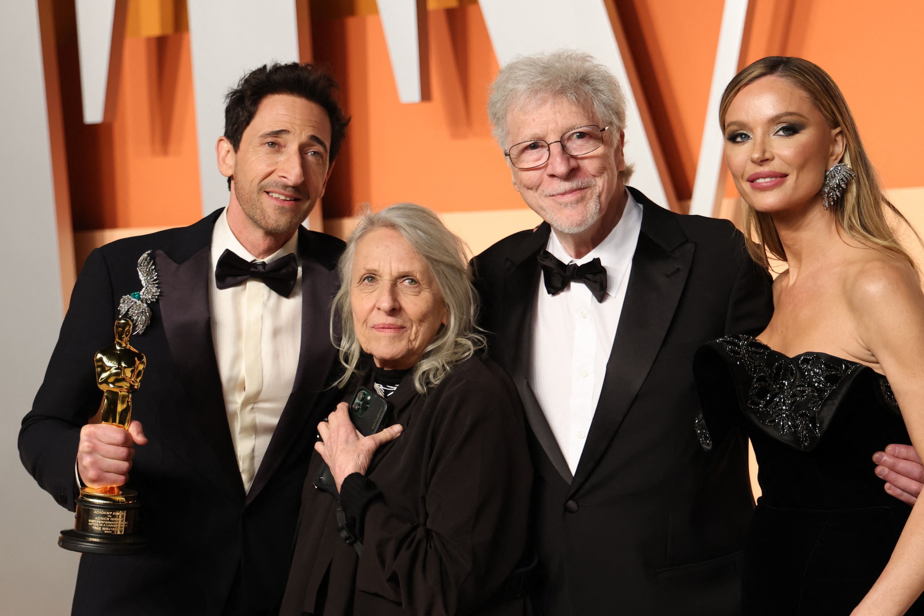 U.S. actor Adrien Brody (L) holds the Oscar for Best Actor in a Leading Role for 