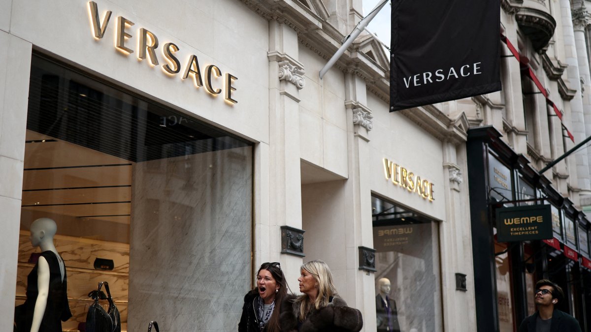 People walk outside a Versace store on New Bond Street, London, U.K., March 11, 2023. (Reuters Photo)