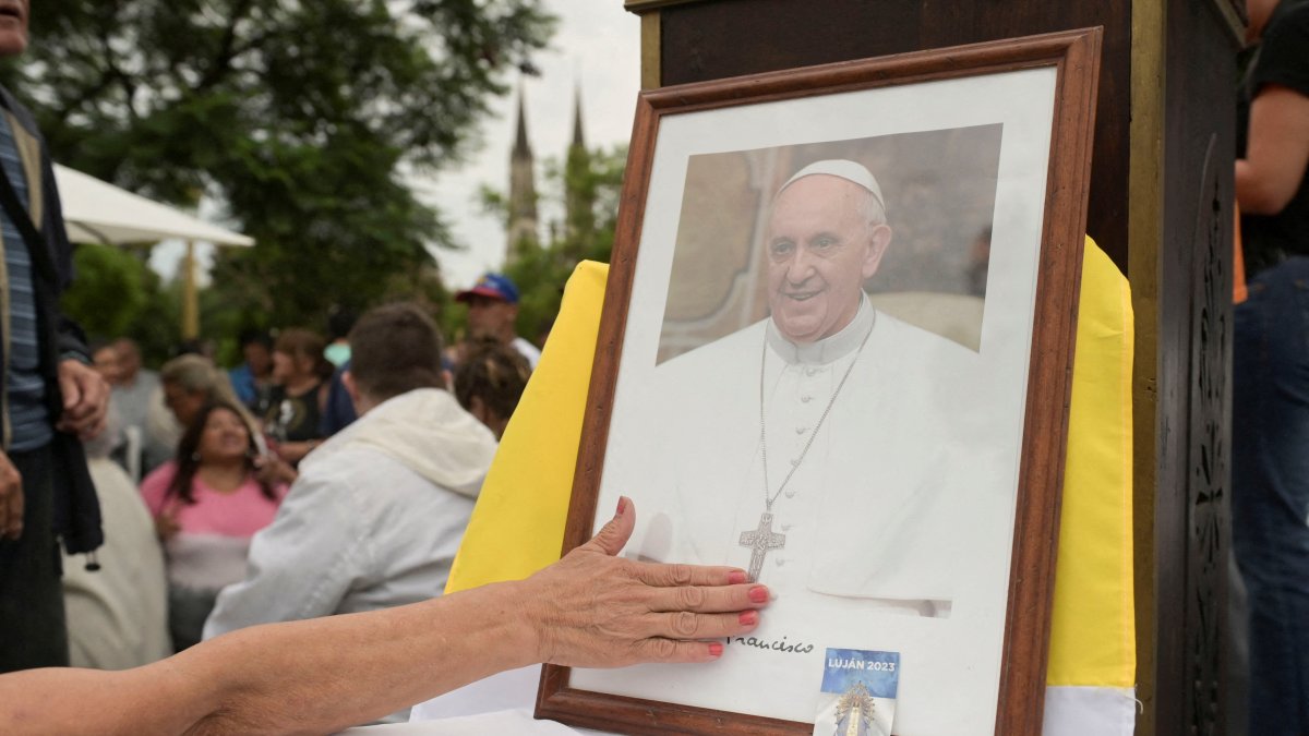 A person touches a portrait of  Pope Francis during a Mass to pray for Pope Francis&#039; health at the Plaza Constitucion in Buenos Aires, Argentina, Feb. 24, 2025. (Reuters File Photo)