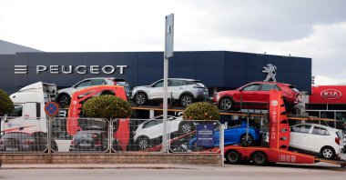 A transport truck carries new Peugeot and Kia cars, Ronda, Spain, Feb. 20, 2025. (Reuters Photo)