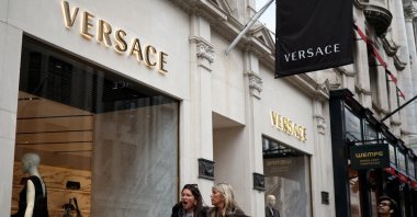 People walk outside a Versace store on New Bond Street, London, U.K., March 11, 2023. (Reuters Photo)
