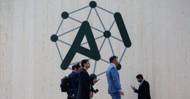 People walk past the logo of the Artificial Intelligence Action Summit at the Grand Palais, Paris, France, Feb. 10, 2025. (EPA Photo)