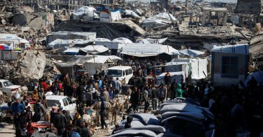Palestinians gather to receive aid provided by UNRWA including food supplies, after Israel says it has ceased entry of humanitarian aid into Gaza, outside a distribution center, at Jabalia refugee camp in northern Gaza Strip, March 2, 2025. (Reuters Photo)