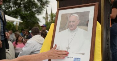 A person touches a portrait of  Pope Francis during a Mass to pray for Pope Francis' health at the Plaza Constitucion in Buenos Aires, Argentina, Feb. 24, 2025. (Reuters File Photo)