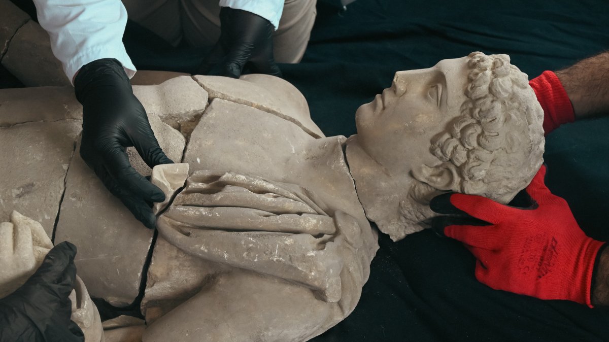 Archeologists work on the marble statue of Hermes discovered in the ancient city of Aspendos, Antalya, southern Türkiye, March 3, 2025. (AA Photo)