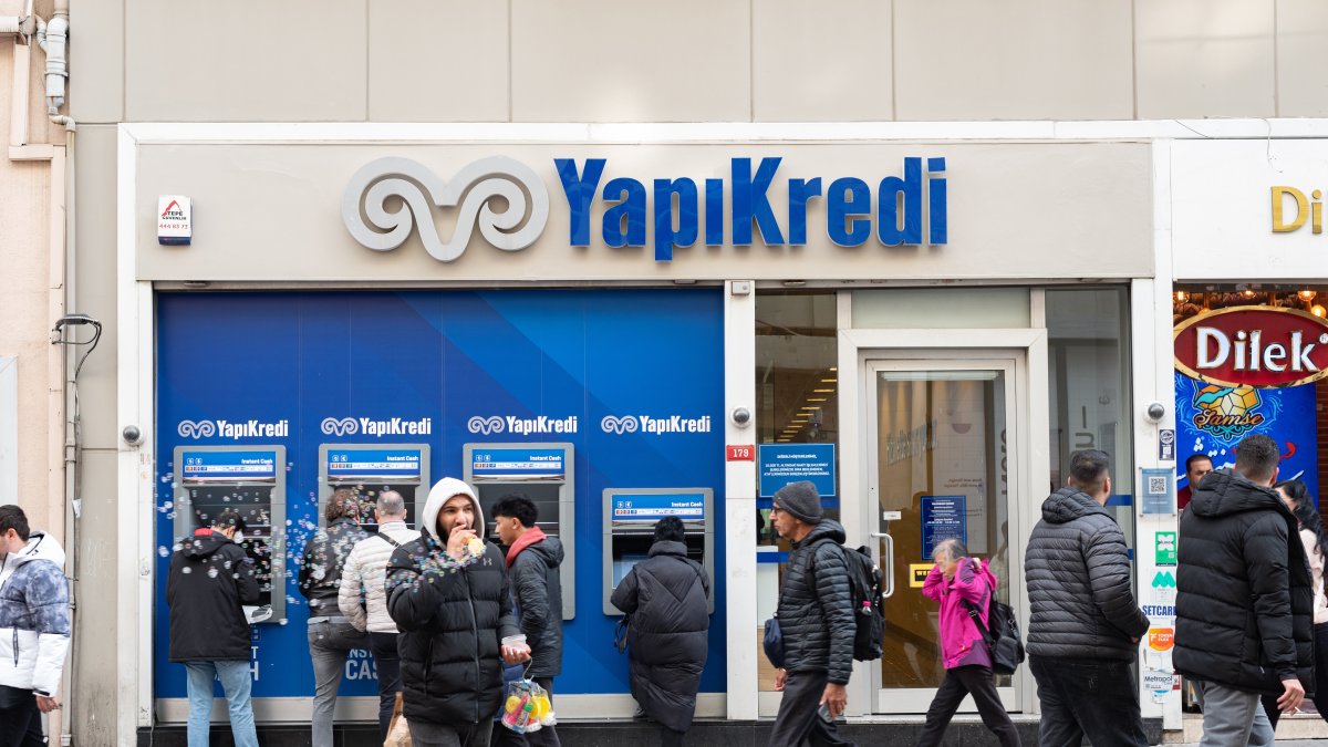 People walk past a Yapı Kredi Bank branch on a busy shopping street, central Istanbul, Türkiye, Jan. 7, 2025. (Reuters Photo)