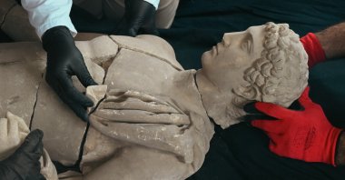 Archeologists work on the marble statue of Hermes discovered in the ancient city of Aspendos, Antalya, southern Türkiye, March 3, 2025. (AA Photo)