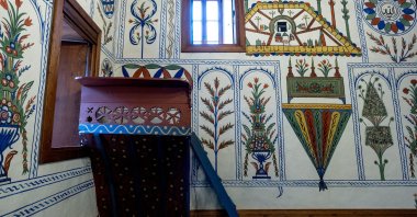 A view of a wall and the sermon platform (vaaz kürsüsü) decorated with penwork and natural dye art at Boğaziçi Mosque in Baklan district, Denizli, western Türkiye, March 3, 2025. (AA Photo)