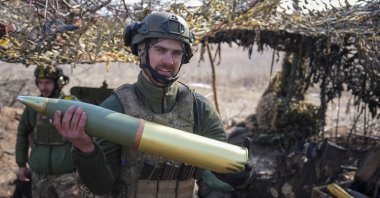 A Ukrainian serviceman carries a shell as he fires an OTO Melara howitzer toward Russian positions, near Pokrovsk in Donetsk region, Ukraine, March 3, 2025. (Reuters Photo)