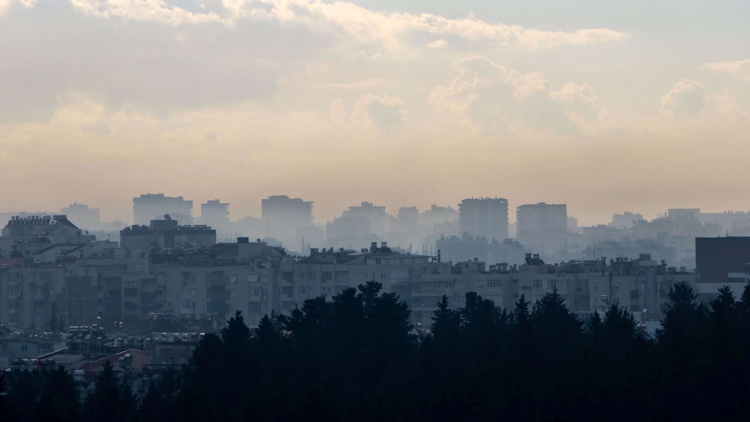 An aerial view of buildings enveloped by smog, Antalya, Türkiye, March 5, 2025. (DHA Photo)