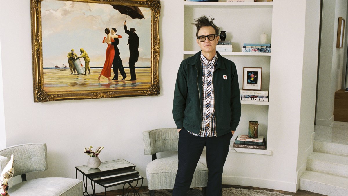 Mark Hoppus of Blink-182 poses by his painting &quot;Crude Oil&quot; (&quot;Vettriano&quot;) by Banksy (2005), sold at auction on March 4 with some of the proceeds going to victims of the Los Angeles wildfires. (Sotheby&#039;s Handout via AP Photo)