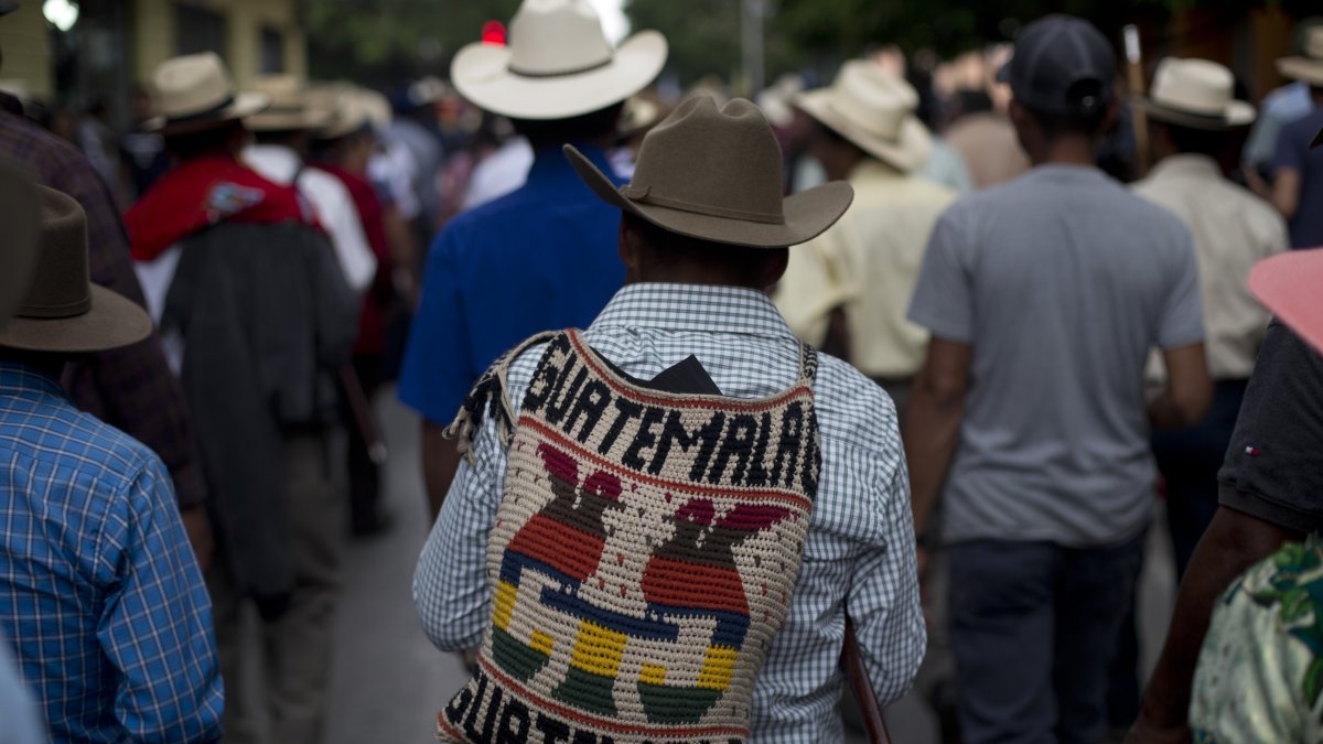 People walk in a street in Guatemala City, Guatemala, May 8, 2019. (AP Photo)