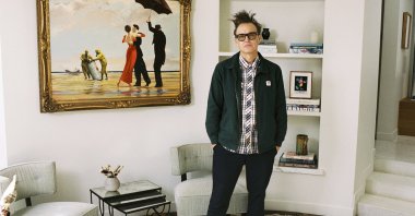 Mark Hoppus of Blink-182 poses by his painting &quot;Crude Oil&quot; (&quot;Vettriano&quot;) by Banksy (2005), sold at auction on March 4 with some of the proceeds going to victims of the Los Angeles wildfires. (Sotheby&#039;s Handout via AP Photo)