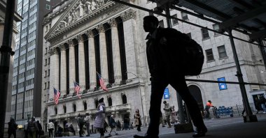 A person walks past the New York Stock Exchange (NYSE) at Wall Street, New York, U.S., Feb. 3, 2025. (AFP Photo)