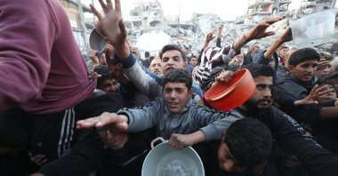 Palestinians queue for hot meal provided by an aid group at the Jabalia refugee camp, nothern Gaza, Palestine, March 4, 2025. (AA Photo)