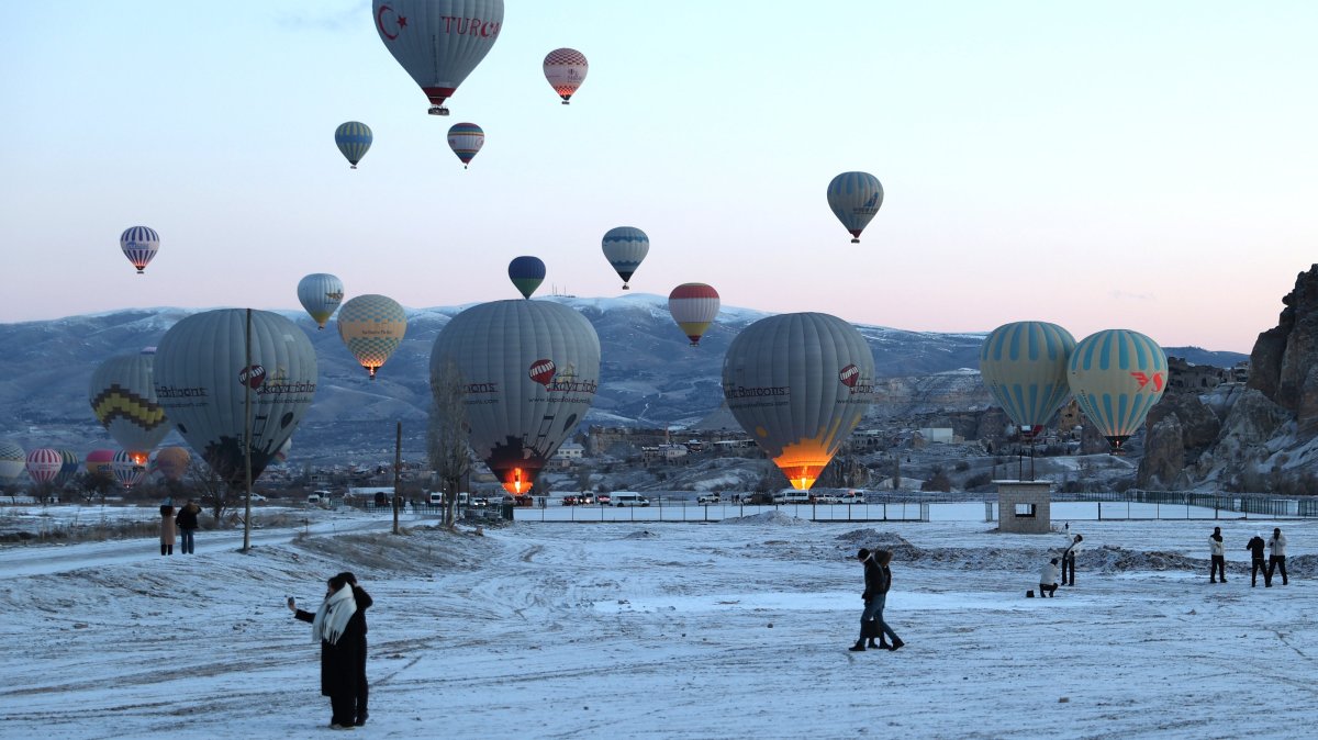 Tourists are seen below hot air balloons, Cappadocia, central Türkiye, Feb. 23, 2025. (AA Photo)