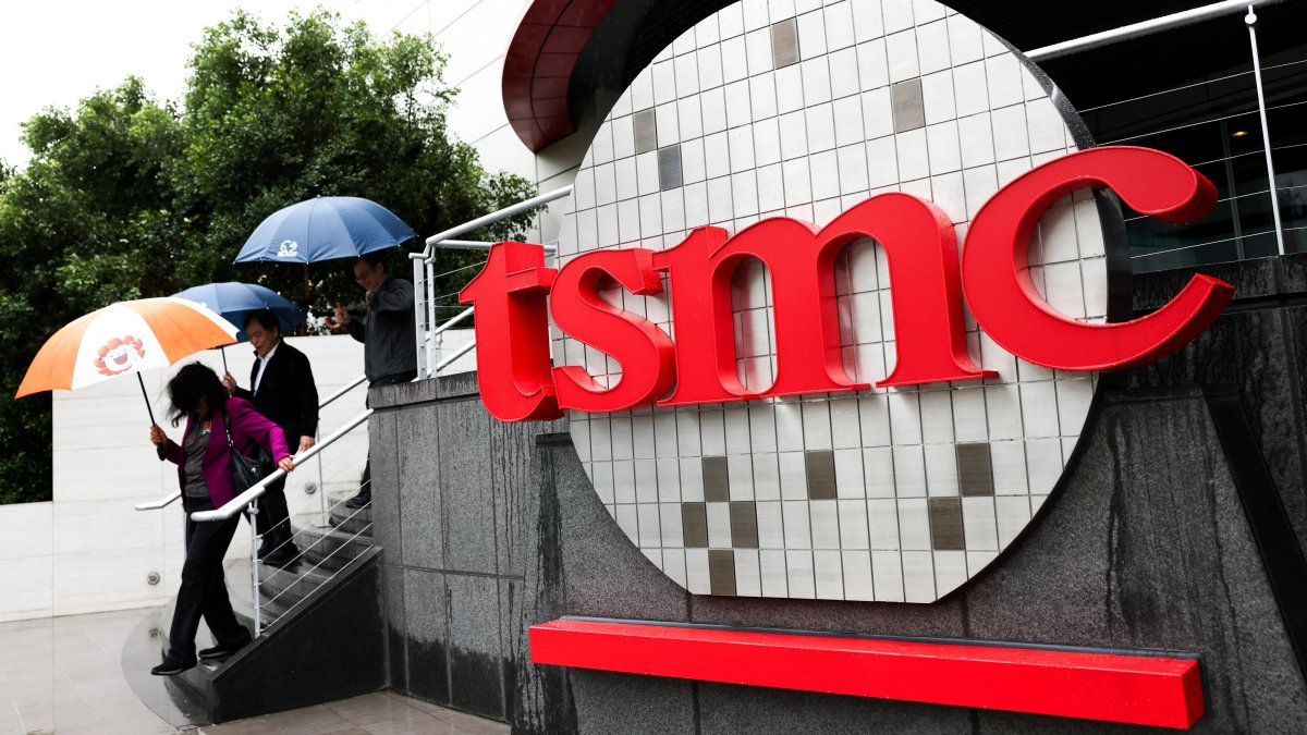 People walk beside a logo outside the Taiwan Semiconductor Manufacturing Company (TSMC) Museum of Innovation at its headquarters, Hsinchu, Taiwan, Nov. 21, 2024. (AFP Photo)