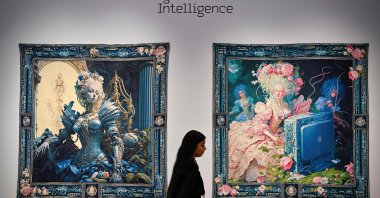 A person walks past AI artwork created by Grimes, Mac Boucher, Mary Jacobo and Eurypheus in New York City, U.S., Feb. 20, 2025. (AFP Photo)