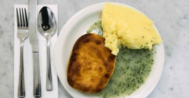 A picture shows a typical portion of pie and mash at G Kelly, east London, U.K., Feb. 19, 2025. (AFP Photo)