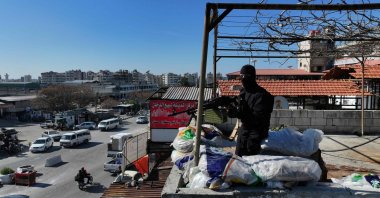 A member of the security forces with Syria&#039;s new government mans a checkpoint at the entrance of the town of Jableh on Jan.28, 2025. (AFP File Photo)