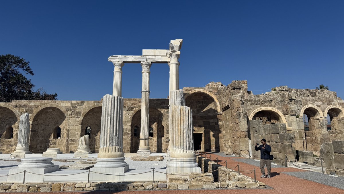 A visitor takes photos of the Athena Temple at Side Ancient City, Antalya, Türkiye, Feb. 12, 2025. (AA Photo)