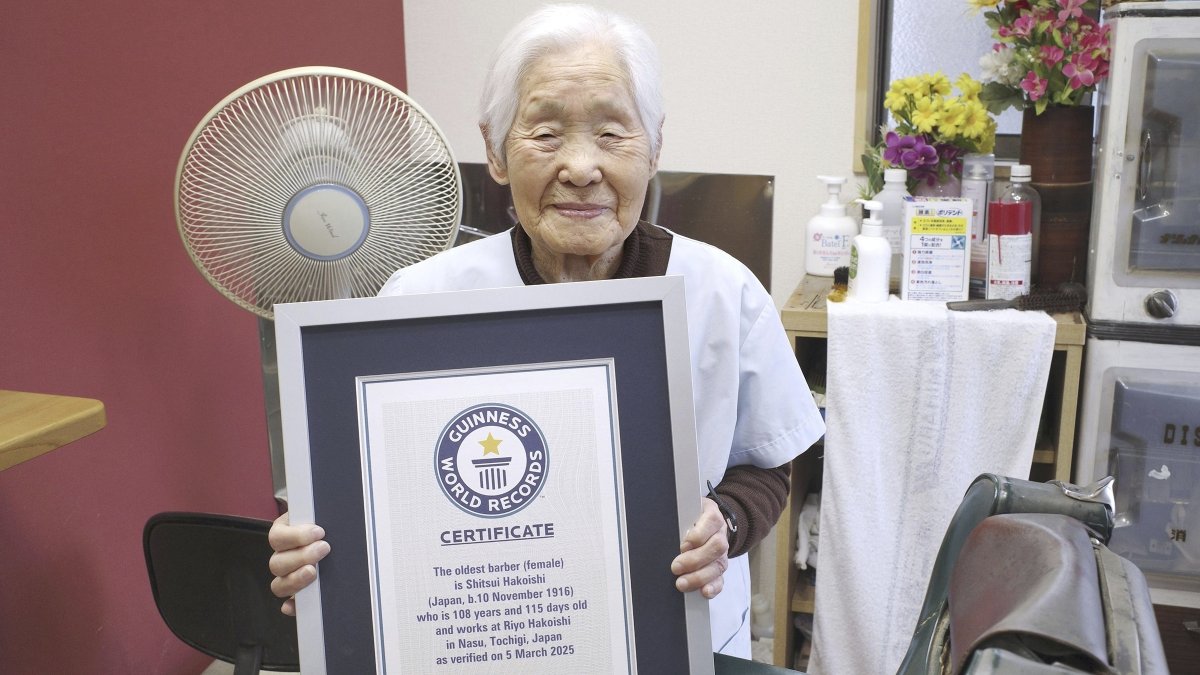 Shitsui Hakoishi, 108, poses for a photo with a Guinness World Records certificate recognizing her as the world&#039;s oldest female barber, at her shop in Nakagawa in Tochigi Prefecture, eastern Japan, March 5, 2025. (AP Photo)