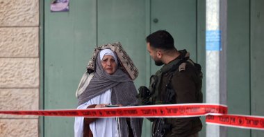 A Palestinian woman talks to an Israeli soldier at a checkpoint as worshippers head to the Al-Aqsa Mosque in East Jerusalem to attend the first Friday prayers of the fasting month of Ramadan, West Bank, Palestine, March 7, 2025. (AFP Photo)
