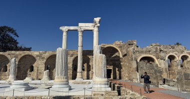 A visitor takes photos of the Athena Temple at Side Ancient City, Antalya, Türkiye, Feb. 12, 2025. (AA Photo)