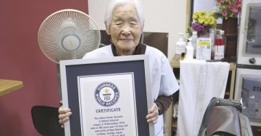 Shitsui Hakoishi, 108, poses for a photo with a Guinness World Records certificate recognizing her as the world&#039;s oldest female barber, at her shop in Nakagawa in Tochigi Prefecture, eastern Japan, March 5, 2025. (AP Photo)