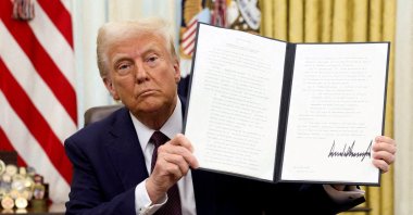 U.S. President Donald Trump holds a signed executive order on cryptocurrencies, the Oval Office of the White House, Washington, U.S., Jan. 23, 2025. (Reuters Photo)