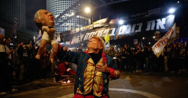 A demonstrator wearing a mask representing U.S. President Donald Trump holds an effigy of Israeli Prime Minister Benjamin Netanyahu during protests, Tel Aviv, Israel, March 8, 2025. (Reuters Photo)