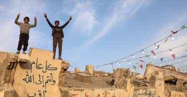 Palestinian children pose for a picture on the debris of a building, Gaza City, Palestine, March 6, 2025. (AFP Photo)