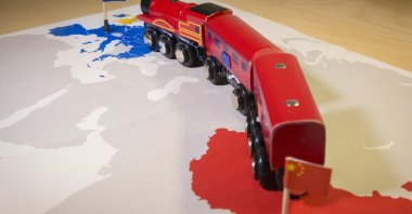A toy train connecting Europa and China, symbolizing the New Silk Road or Chinese BRI economic investment project. (Shutterstock Photo)