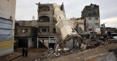 Palestinian women walk near a fallen minaret of a destroyed mosque during the Islamic holy fasting month of Ramadan, Nuseirat refugee camp, central Gaza Strip, Palestine, March 7, 2025. (AFP Photo)