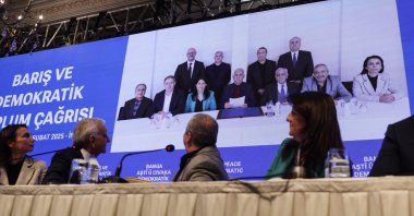 The Peoples&#039; Equality and Democracy Party (DEM) delegation shows a photo of themselves with Abdullah Öcalan (screen C) during a news conference, Istanbul, Türkiye, Feb. 27, 2025. (EPA Photo)