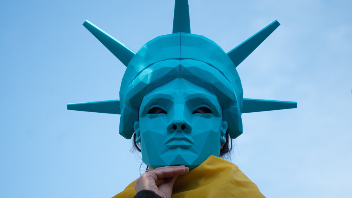 A demonstrator wearing a Statue of Liberty mask during a protest against the actions of the U.S. President Donald Trump administration, Kyiv, Ukraine, March 8, 2025. (AA Photo)