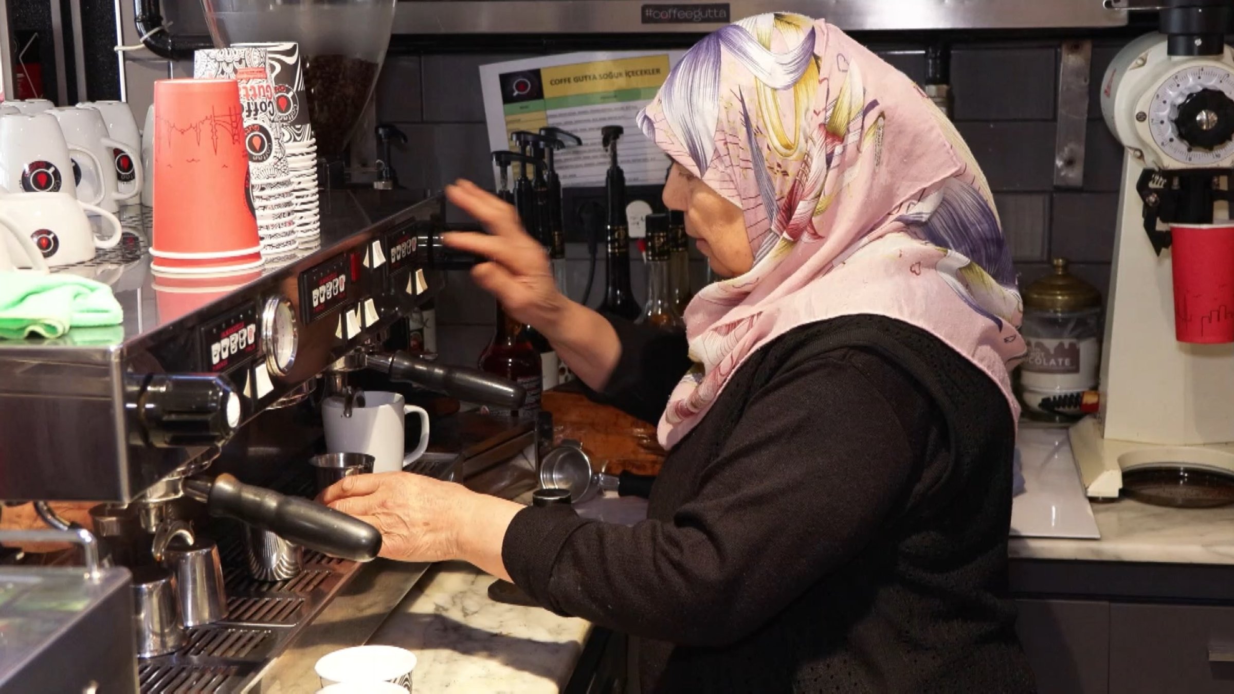 Hava Çal prepares coffee at her daughter&#039;s cafe, Fatih, Istanbul, Türkiye, March 9, 2025. (DHA Photo)