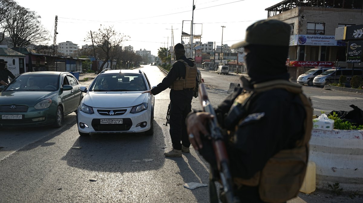 Members of the Syrian security forces stop vehicles at a checkpoint following clashes between government forces and supporters of the former Syrian regime, in Jableh town of Latakia, Syria, March 9, 2025. (EPA Photo)