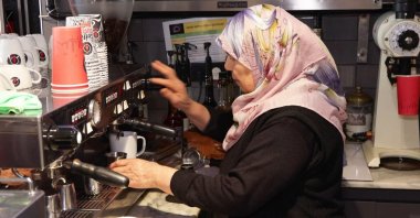 Hava Çal prepares coffee at her daughter's cafe, Fatih, Istanbul, Türkiye, March 9, 2025. (DHA Photo)