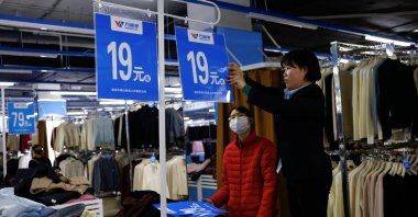Staff members change price tags at a clothing section at the Wankelai store, Beijing, China, Feb. 27, 2025. (Reuters Photo)