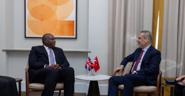 Foreign Minister Hakan Fidan (R) and U.K. Foreign Secretary David Lammy speak during a meeting, Munich, Germany, Feb. 14, 2025. (IHA Photo)