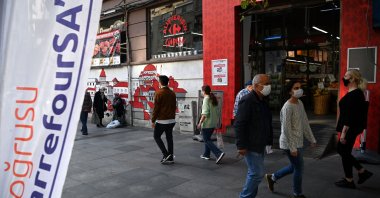 People walk in front of a French brand supermarket &quot;Carrefour&quot; in the Nişantaşı neighborhood, Istanbul, Türkiye, Oct. 26, 2020. (AFP Photo)