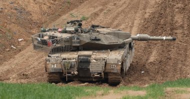 This picture taken from the Israeli side of the border with the Gaza Strip shows an Israeli army tank stationed on a hill overlooking northern Gaza, Feb. 12, 2025. (AFP File Photo)