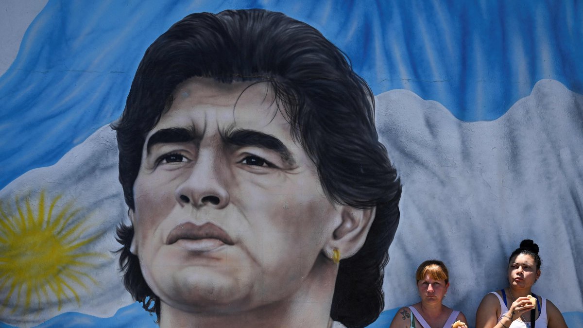 Members of social organizations stand next to a mural depicting late Argentine football star Diego Maradona during a protest at Pueyrredon Bridge, Buenos Aires, Argentina, Dec. 2, 2022. (AFP Photo)