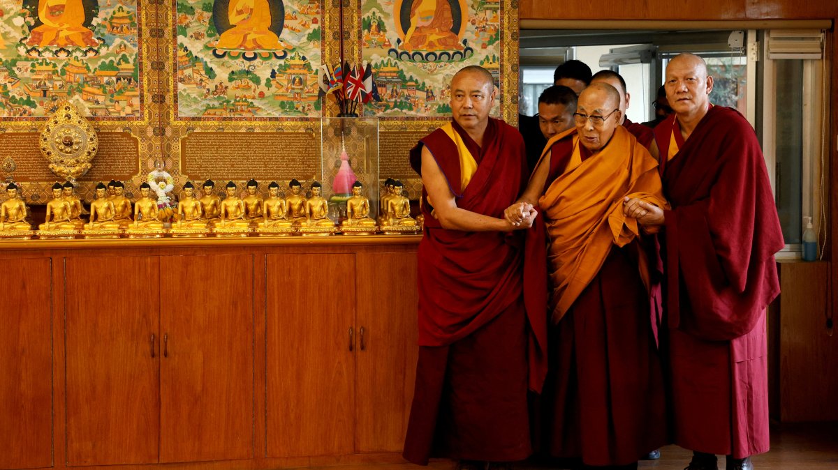 Tibetan spiritual leader, the Dalai Lama, is escorted into a hall by monks holding his hands at his Himalayan residence, Dharamshala, India, Dec. 20, 2024. (Reuters Photo)