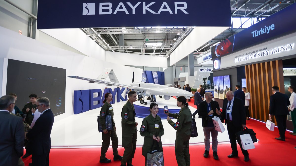 Visitors walk near a Turkish Bayraktar TB2 drone inside a hall of the 30th International Defense Industry Exhibition in Kielce, Poland, Sept. 6, 2022. (AA Photo)