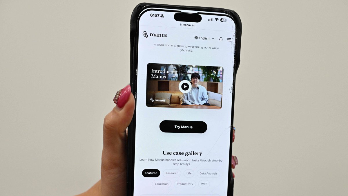 A photo illustration shows a mobile phone displaying an introduction screen for the AI assistant tool Manus, released by Chinese startup Butterfly Effect, Beijing, China, March 11, 2025. (AFP Photo) 