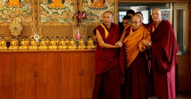 Tibetan spiritual leader, the Dalai Lama, is escorted into a hall by monks holding his hands at his Himalayan residence, Dharamshala, India, Dec. 20, 2024. (Reuters Photo)